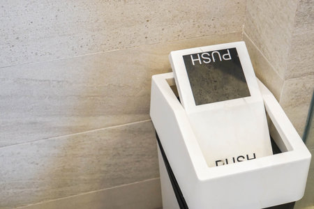 close up white bin to push trash in hotel restroom