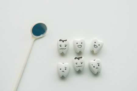 isolated health icon concept of teeth examined for healthy and decayed teeth by dentistの写真素材