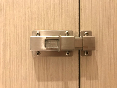 stainless door bolt on the wooden toilet door