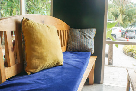 pillow on wooden sofa at hotel lobby for guests