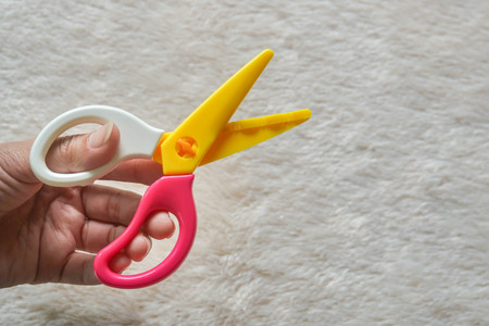 woman left hand with zigzag scissors for craft workの写真素材