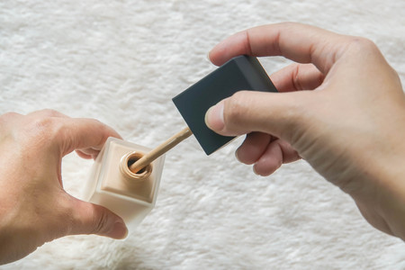 close up woman apply liquid foundation from the bottle for make upの写真素材
