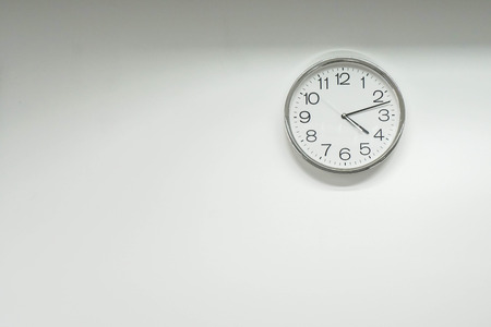 isolated round clock on office wallの写真素材