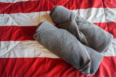 top view of grey neat cotton towel on hotel bedroomの写真素材