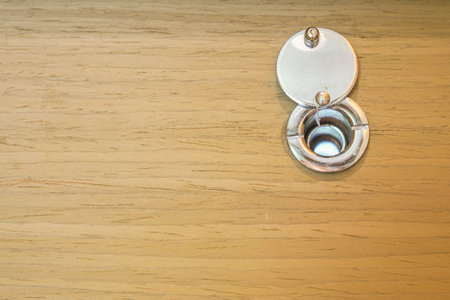close up peephole on the hotel wooden door for looking and security before opening