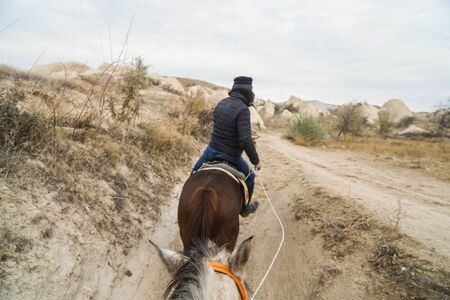 selective focus on white horse head and hair on horse riding guided by local tour guide in Cappadocia, Turkeyの写真素材