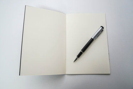 top view of mock up business notebook with writing pen in office for meeting