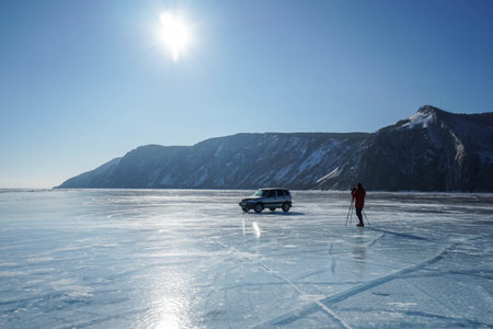 Olkhon Island / Russia - February 6 2020: frozen Baikal Lake with tourist and car in bright sunny day with blue skyのeditorial素材