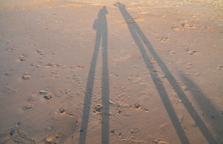 love and romantic concept of shadow couple on sand beach in sunset moment