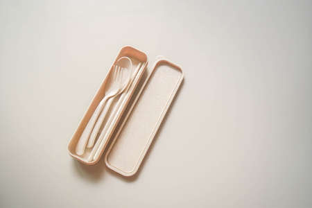 isolated top view eco-friendly fork, spoon and chopsticks in  handy box for eating and sustainableの写真素材