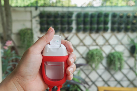 close up woman hold handle alcohol gel bottle to clean hands for Covid-19 protection