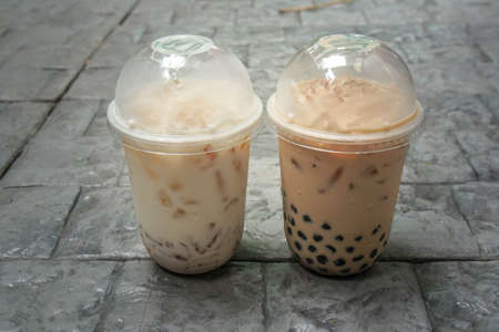 selective focus unhealthy iced bubble milk tea in plastic cupsの写真素材