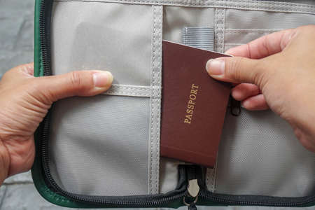 close up woman pull passport book for travel planの写真素材