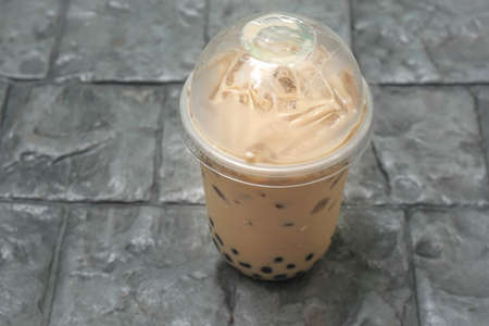 unhealthy drink of iced bubble milk tea in plastic cupsの写真素材