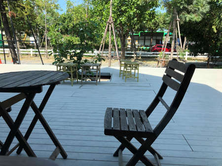 close up vintage wooden chair with round table at outdoor cafeの写真素材