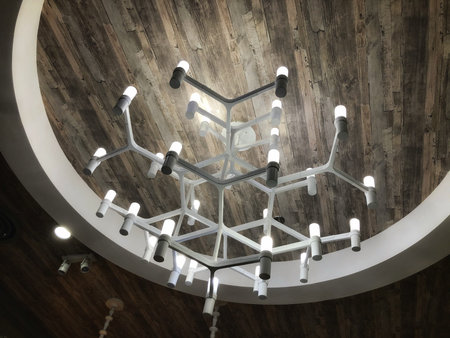 hanging white glow chandelier on the ceiling of dining room