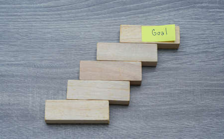 success in people lift concept - step by step to achieve the goals with wood backgroundの写真素材