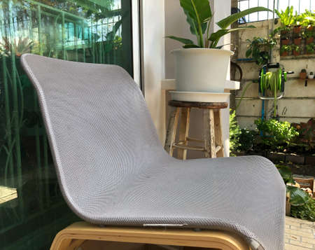 close up modern textile chair at house terrace with gardenの写真素材