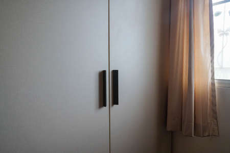 silhouette close up wooden wardrobe handle in master bedroomの写真素材