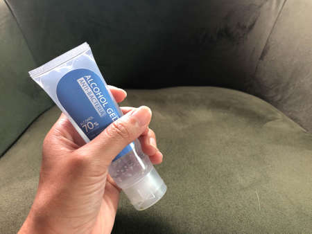 close up woman hand holds anti-bacteria alcohol gel bottle in hand for sanitary to virus protectionの写真素材