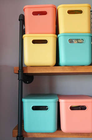cute creative design of green orange and yellow plastic container on the bedroom shelf for storageの写真素材