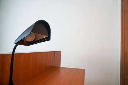Noise with grain vintage light bulb with black metal frame at working desk in bedroomの写真素材