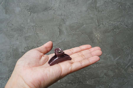 plastic hair clip on woman left hand for hairdoの写真素材