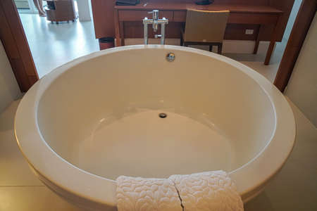 Silhouette flat lay white luxury round bathtub in sexy bathroom in hotel honeymoon bedroom with white cotton matの写真素材