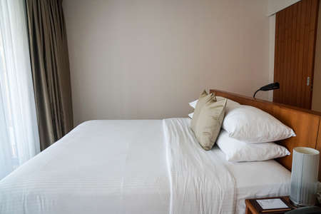 close up minimal double bed with white mattress in luxury hotel bedroom for honeymoon in holidaysの写真素材