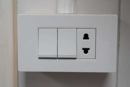 selective focus on light switch button panel at the house wall for lightingの写真素材