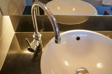 faucet and luxury washbasin in luxury hotel bathroom for face and hand washの写真素材