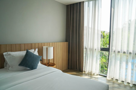 close up minimal bedroom interiors with double bed with white mattress in luxury hotel bedroomのeditorial素材
