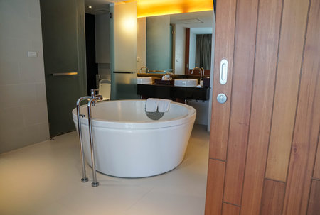 white bathtub in sexy open bathroom in hotel bedroom with luxury decoration style for honeymoon in holidaysのeditorial素材