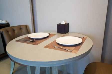 close up white ceramic dish on wooden dining table for couple dinner at homeの写真素材