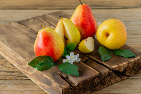 Ripe pears fruit. Harvested organic pear on cutting board on wooden table. Autumn harvest
