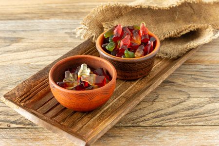 colorful candy and jelly sweet, jelly candy flavor fruit, candy dessert in clay bowls in wooden...