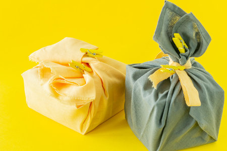 Zero waste, eco-friendly gift wrapping in traditional Japanese Furoshiki style, environmental...