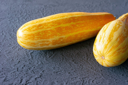 yellow zucchini on gray background in colors of the year 2021 - Illuminating yellow and ultimate gray.の写真素材