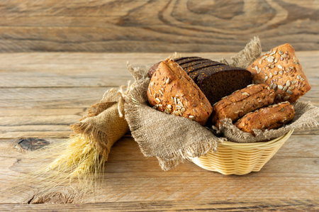 Composition of various baked products in basket on rustic background. Homemade fresh pastry.