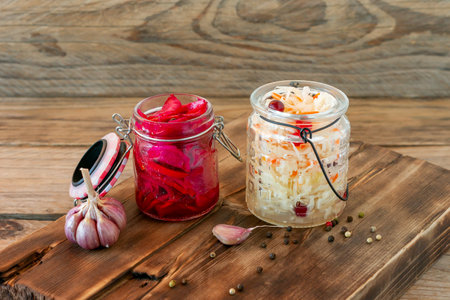 Sauerkraut variety preserving jars. Homemade Sauerkraut with Carrot and Salad Cabbage with Beetroot on a wooden table. Fermented foodの写真素材