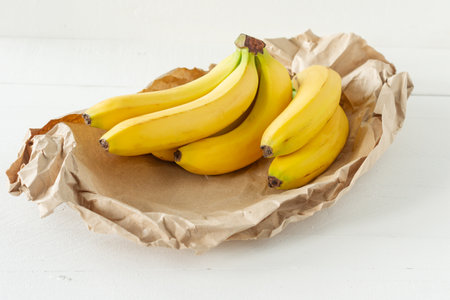 Ripe bunch of bananas in paper bag. Healthy eating concept.の写真素材