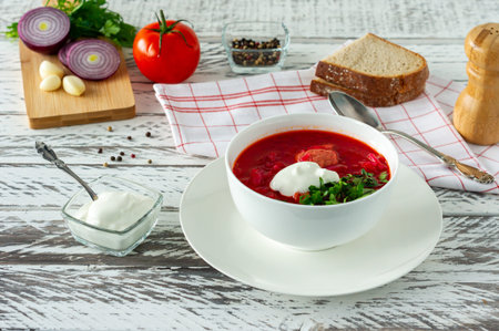 Traditional Ukrainian Russian borscht with garlic and bread. A bowl of red beetroot borscht on a...