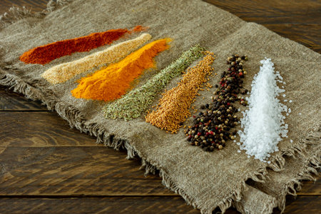 Various powder spices on wooden table. Background with space for text, food or cooking concept