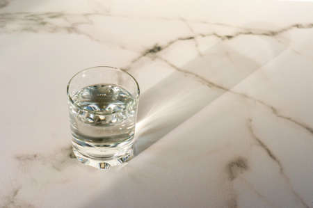 A glass of purified fresh drinking water on a marble table. copy space for text.の写真素材