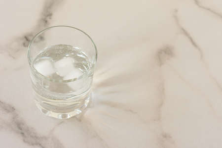 A glass of purified fresh drinking water on a marble table. copy space for text.の写真素材