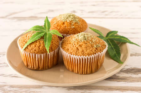 Cupcake with marijuana. Tasty cupcake muffins with cannabis weed cbd. Medical marijuana drugs in food dessert, ganja legalizationの写真素材