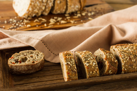 Gluten-free vegan bread and no animal products. Vegetarian bread with oatmeal, banana flavor, on a wooden rustic table, sliced and ready to serveの写真素材