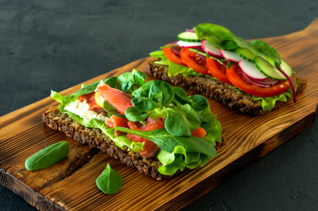 vegetables and smoked open sandwiches with cottage cheese, lattice, tomatoes and lemon on a wooden desk. Healthy breakfast for diet.の写真素材