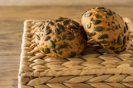 Homemade Gluten-free vegan pumpkin scones with seeds on wooden table.