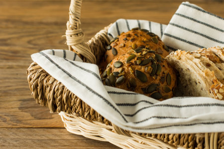 Homemade Gluten-free vegan pumpkin scones with seeds in a basket on wooden table.の写真素材
